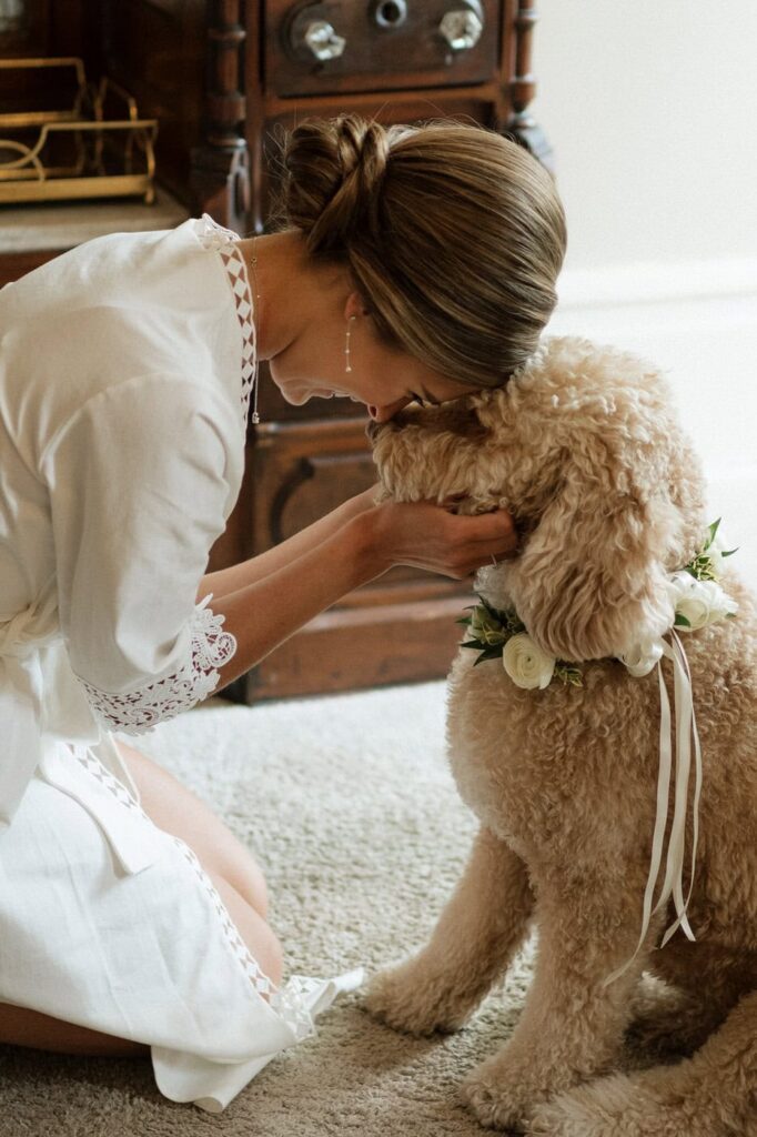 bride having a sweet moment with her dog at nashville wedding venue