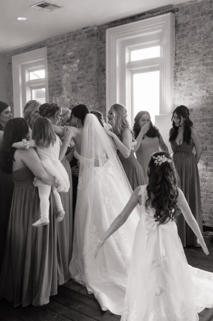bride hugging her friends in the loft at nashville wedding venue