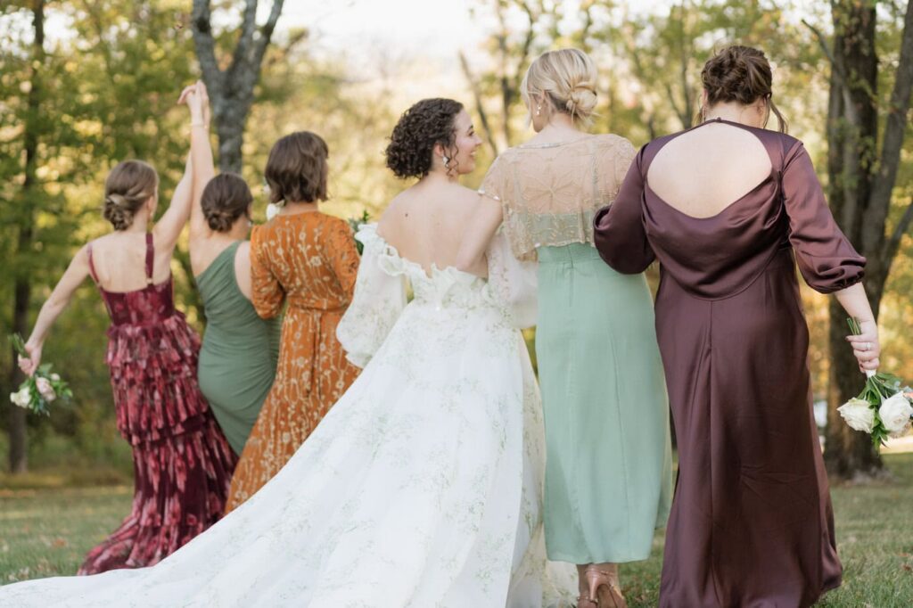 bridal party laughing and walking at trinity view farm in nashville tennessee