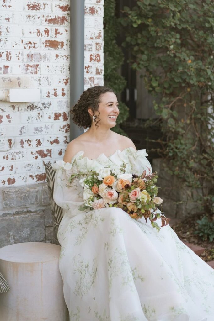bride sitting and laughing before wedding ceremony in nasvhille