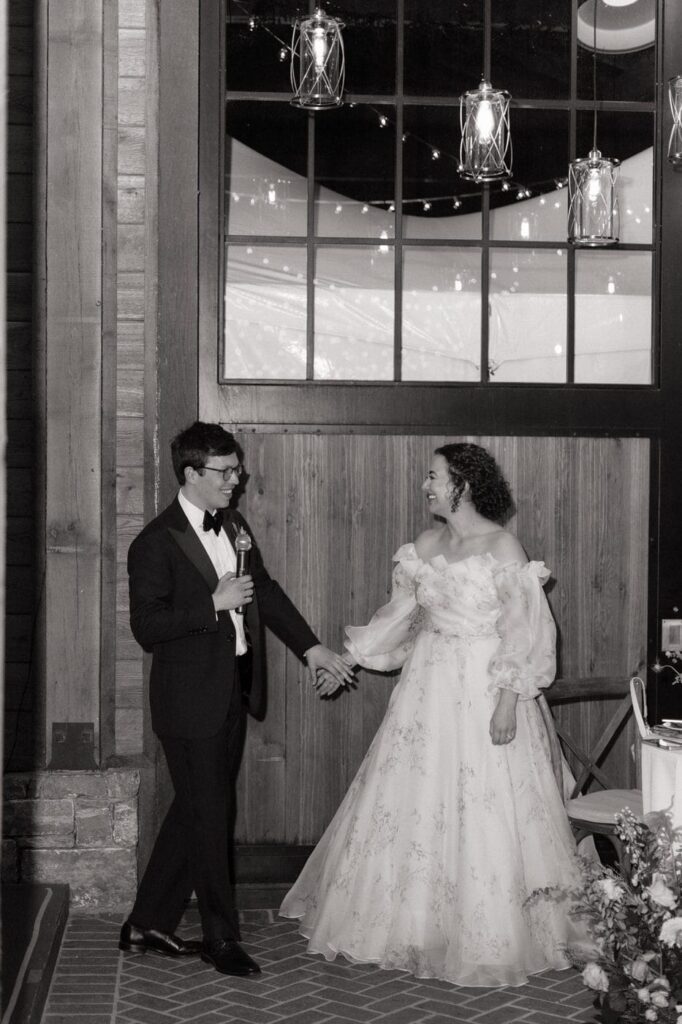 bride and groom speaking at their wedding reception