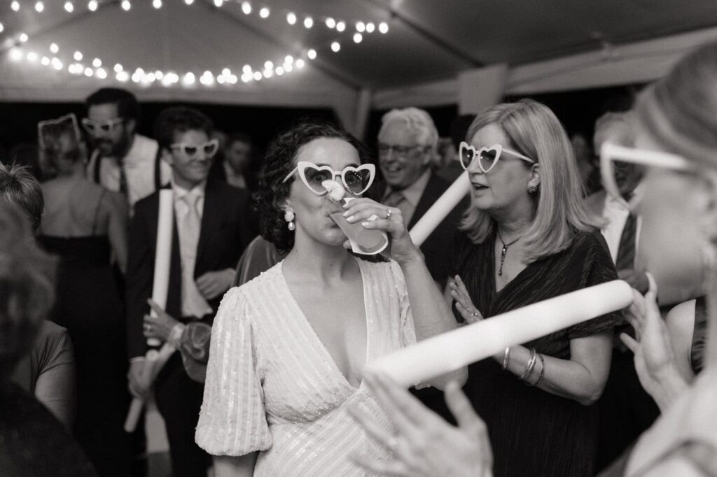bride sipping cocktail during wedding reception in nashville