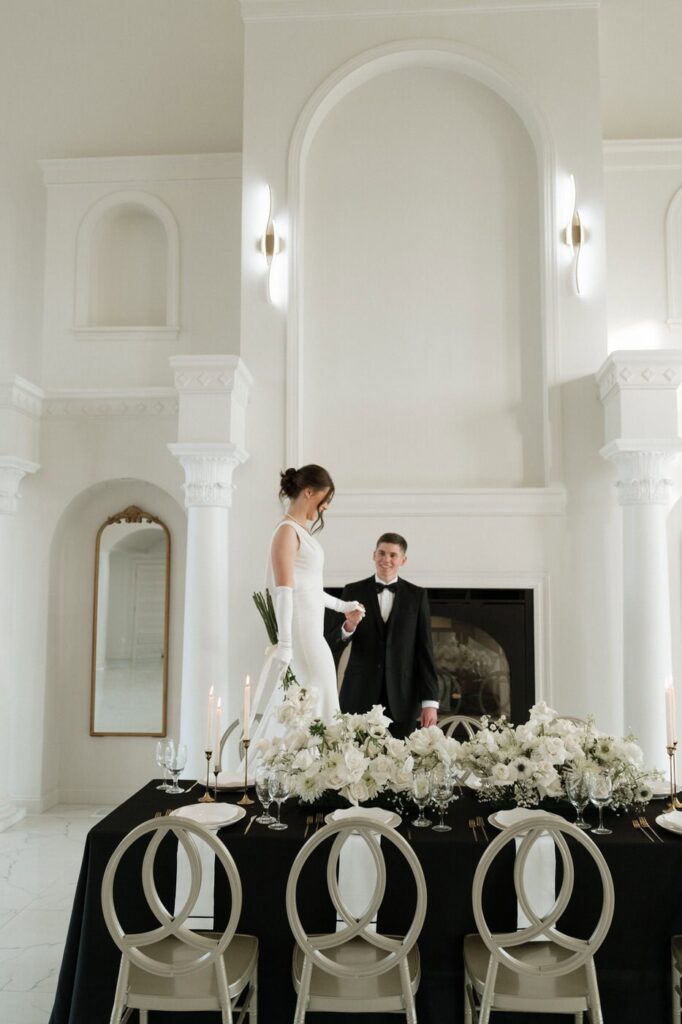 Bride and groom in white reception hall at The Dimora 