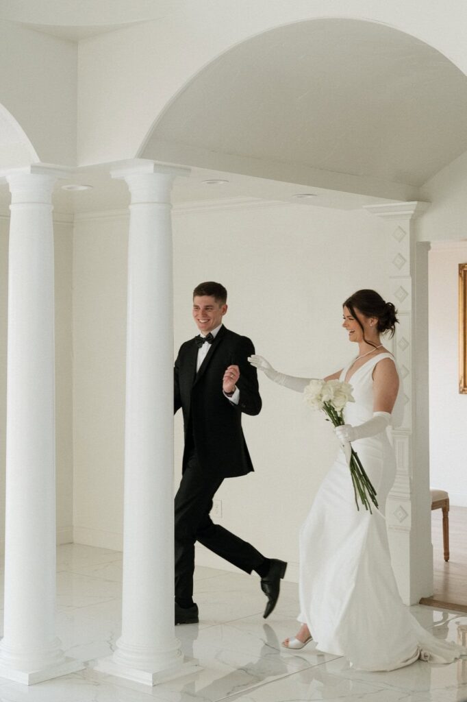 Couple near arched windows at The Dimora wedding venue