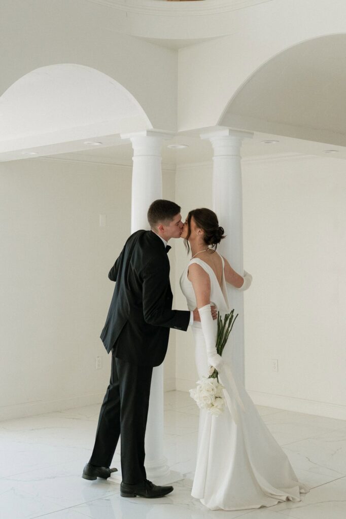 couple sharing a kiss inside the reception hall at tennessee wedding venue