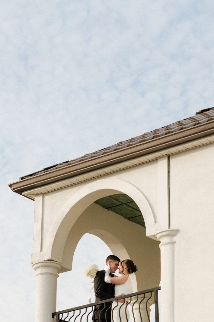 Bride and groom on stone terrace at winter wedding at the dimora