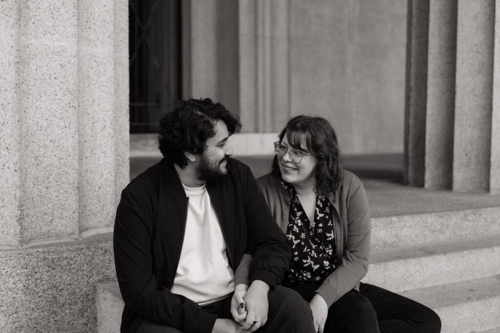 couple smiling at each other during centennial park engagement photos