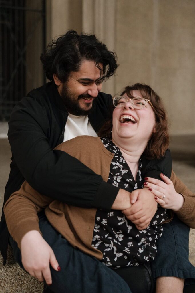 couple laughing on the steps of the parthenon in nashville