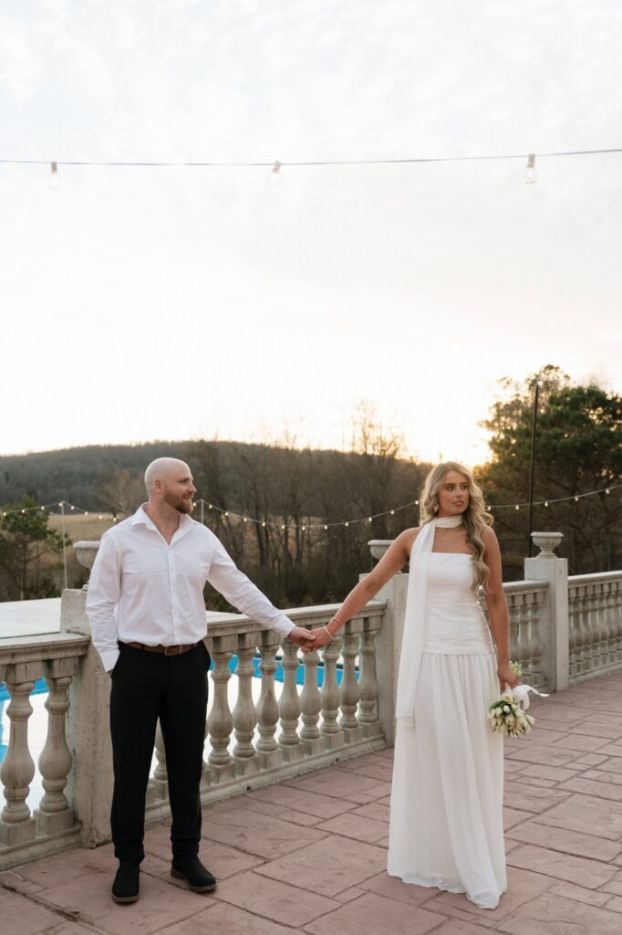 couple holding hands at golden hour engagement session