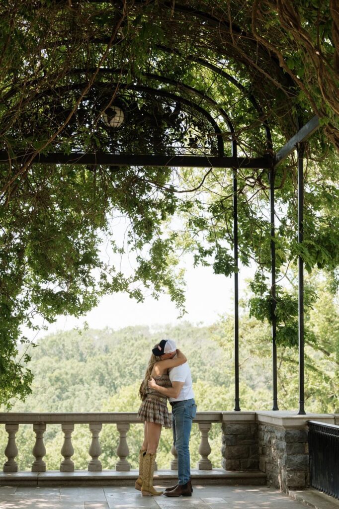 couple hugging after proposal at cheekwood in nashville