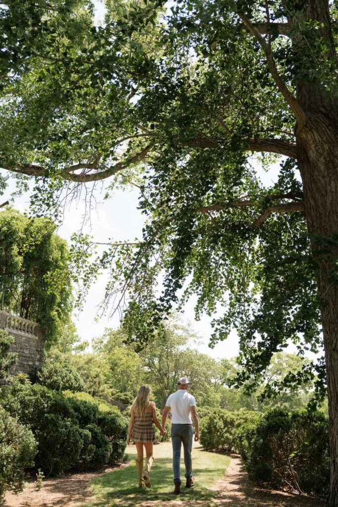 couple holding hands and walking at cheekwood in the spring
