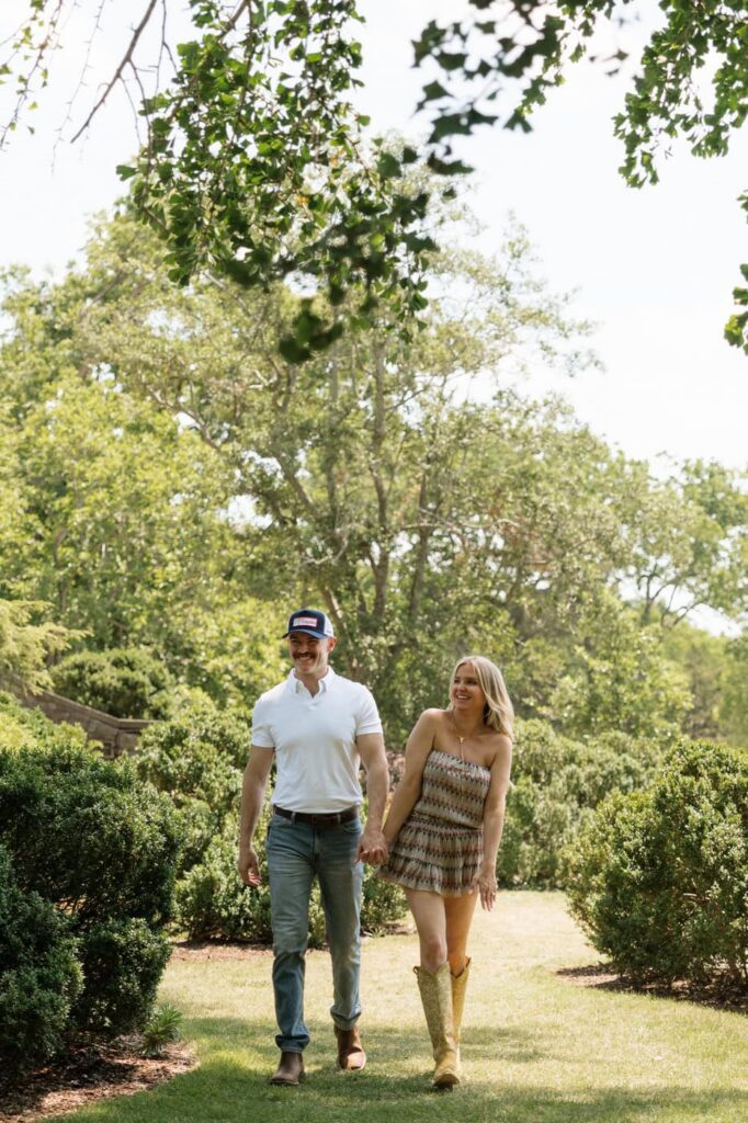 couple laughing and holding hands at cheekwood in nashville