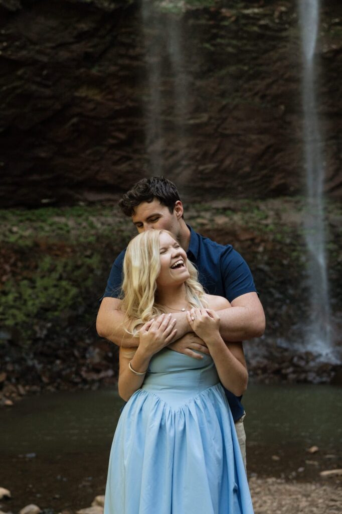 couple embracing and laughing during engagement session in spring in tennessee
