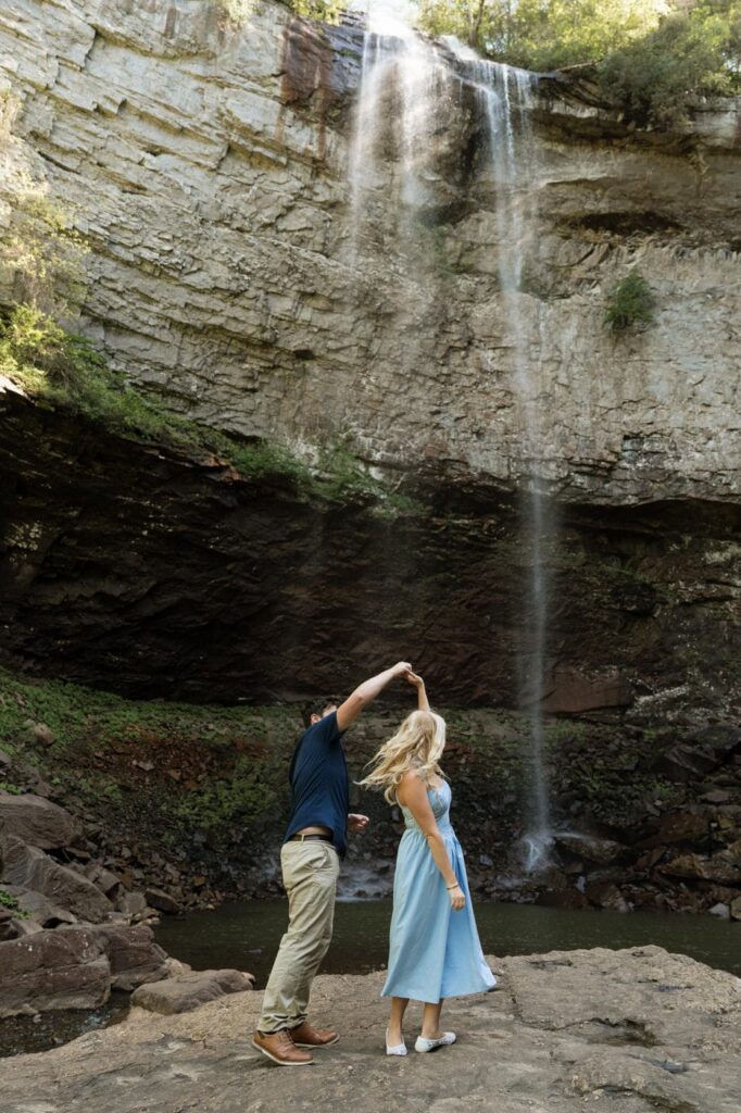 couple dancing in front of the waterfalls in the state park