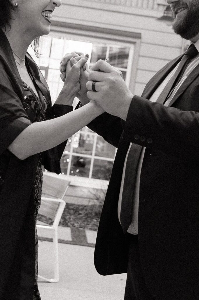 couple holding hands and dancing during engagement photos in nashville