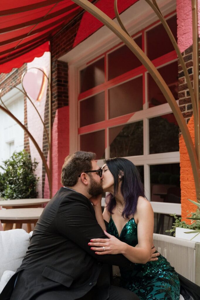 couple kissing on a couch dring midtown nasvhille engagement session