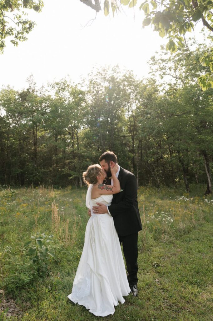 sweet moment between bride and groom kissing in a field in nashville