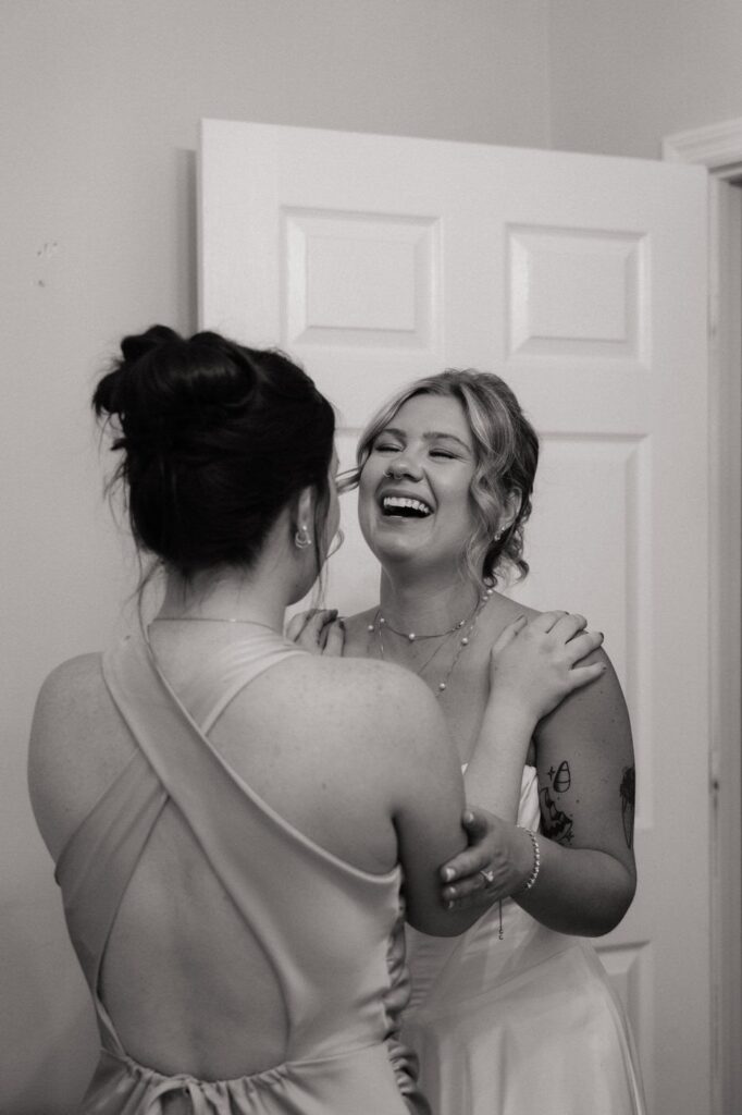 bride and her maid of honor laughing in the bridal suite at stone gate farm in nashville tennessee