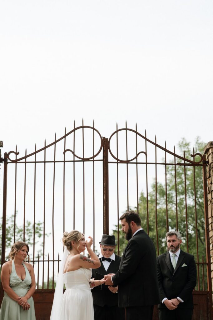 bride wiping away tears at stone gate farm wedding in tennessee
