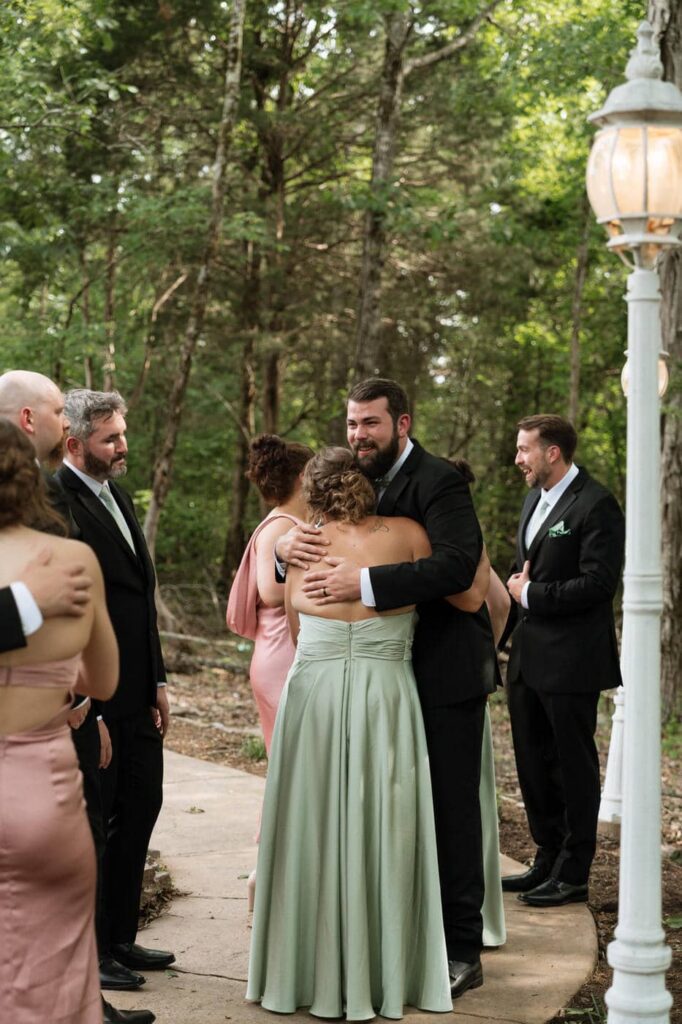 groom hugging bridal party members after wedding ceremony in nashville