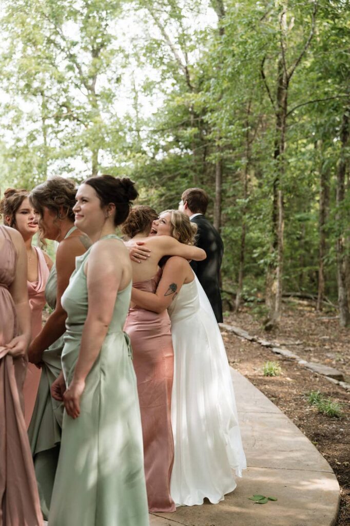 bride hugging bridesmaids after the ceremony at nashville wedding