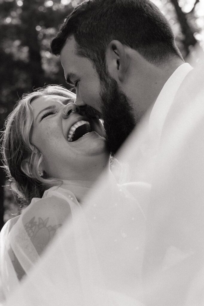 bride and groom laughing during portraits at stone gate farm in nashville tennessee