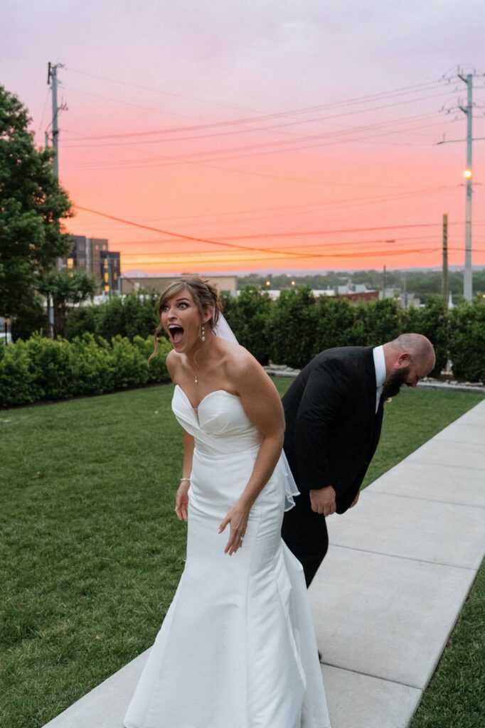bride and groom laughing outside of the estelle at sunset