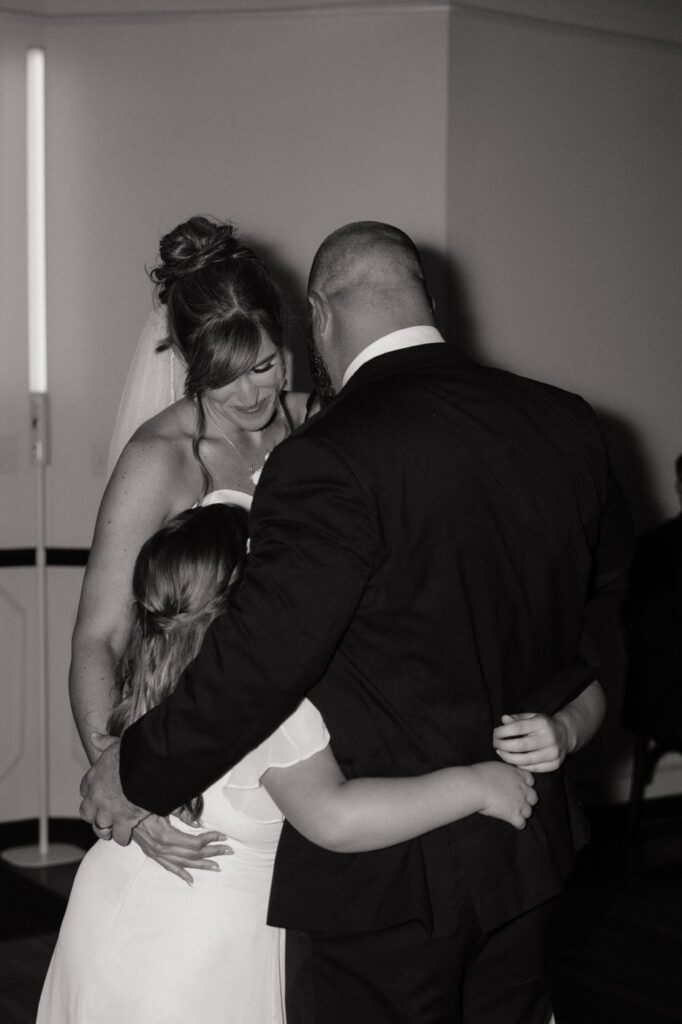 bride and groom first dance with their daughters