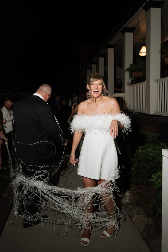 bride laughing at send off after wedding reception