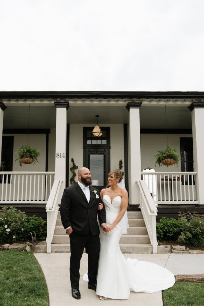 bride and groom standing outside the estelle in east nashville