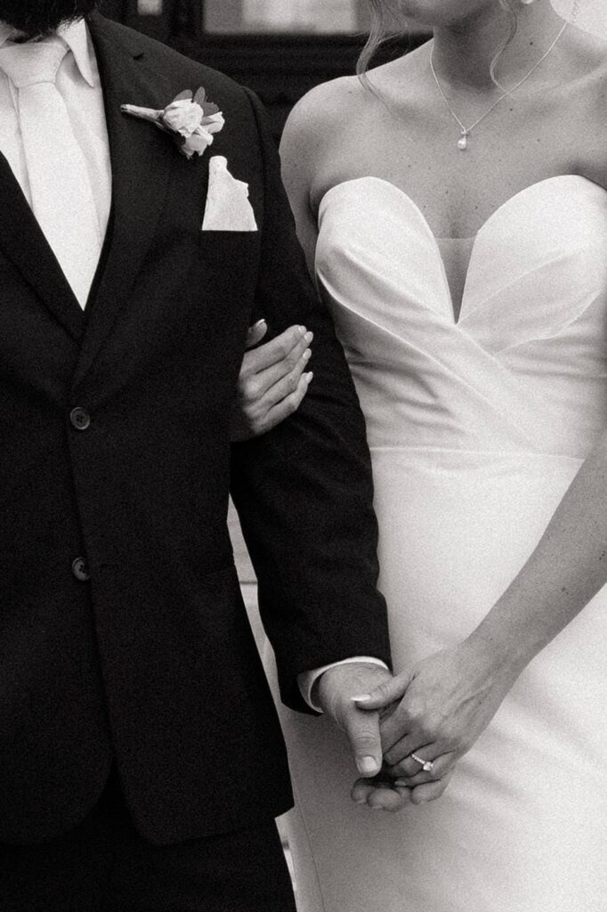 close up photo of bride and groom holding hands