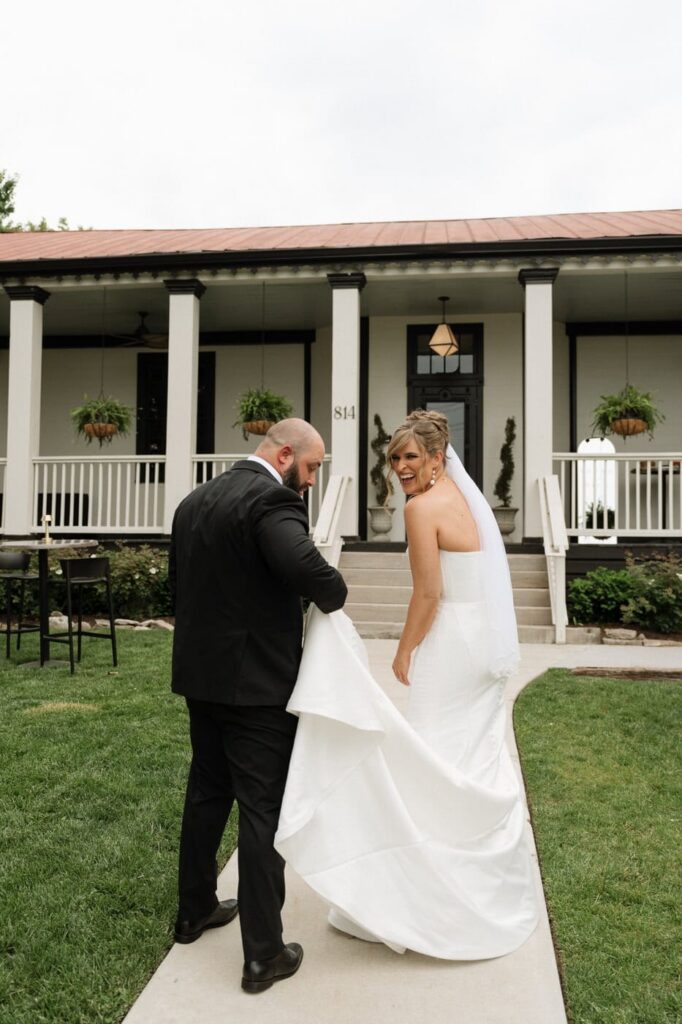 couple laughing while walking outside of the estelle in nashville