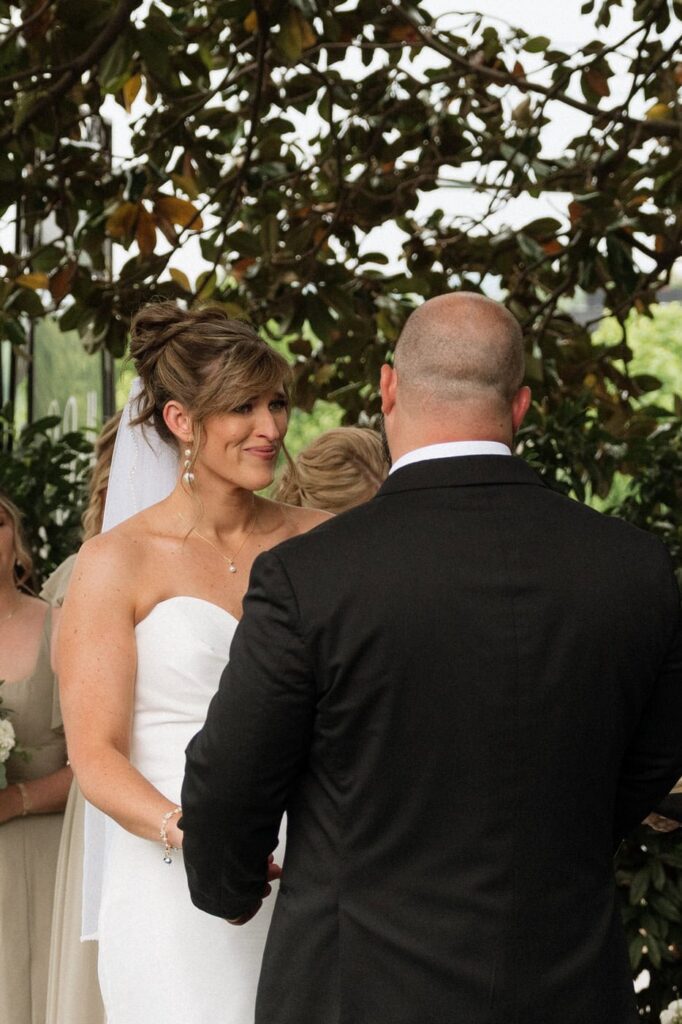 bride tearing up at the groom during the ceremony at the estelle in east nashville
