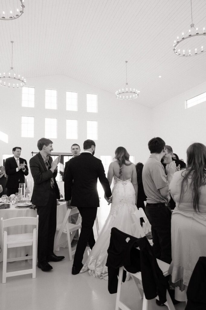 couple walking through the reception crowd to the dance floor at nashville wedding venue