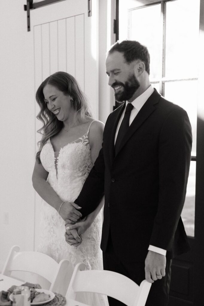 couple holding hands and smiling during the dinner blessing at the monroe on 415th