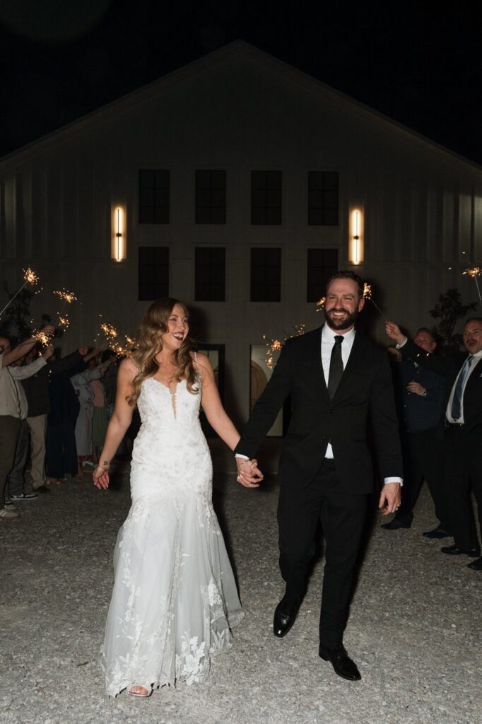 couple laughing after exiting their wedding at the monroe on 415th wedding in spring