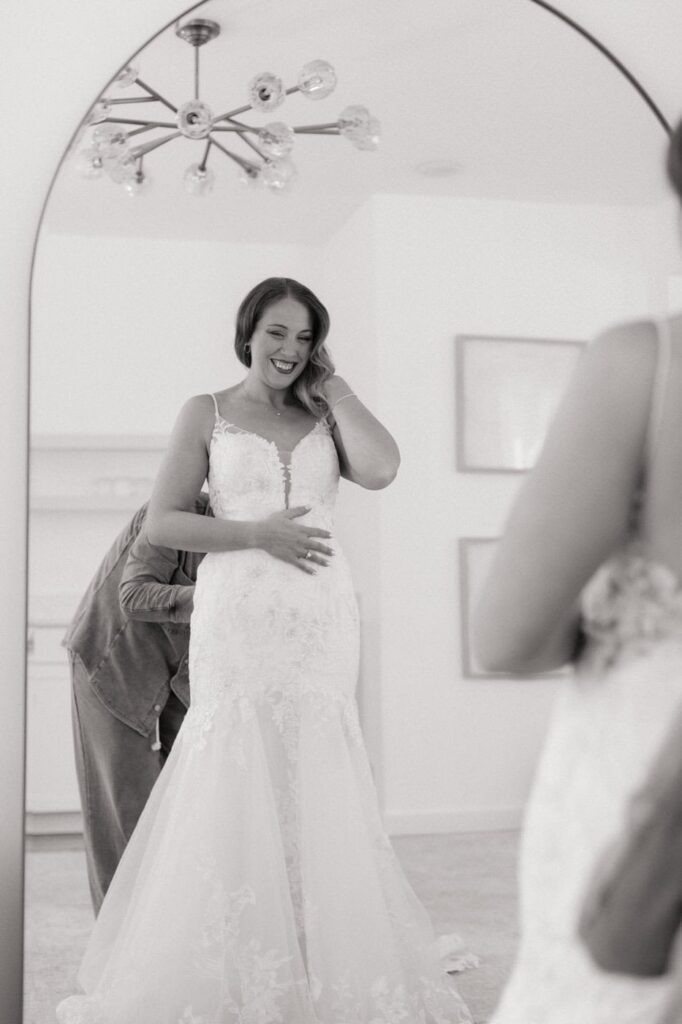 bride looking in the mirror at the monroe on 415th wedding venue