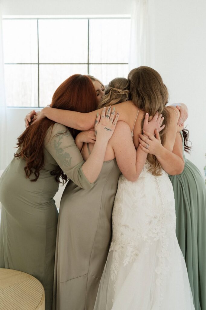 bride hugging her bridesmaids