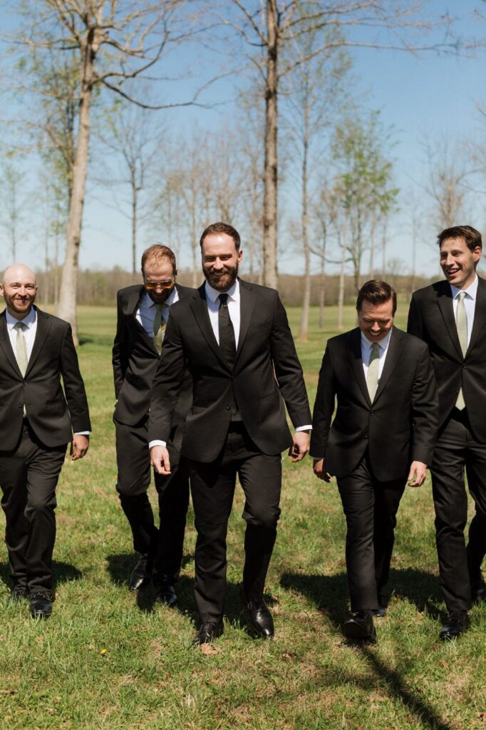groomsmen laughing and walking at the monroe on 415th wedding