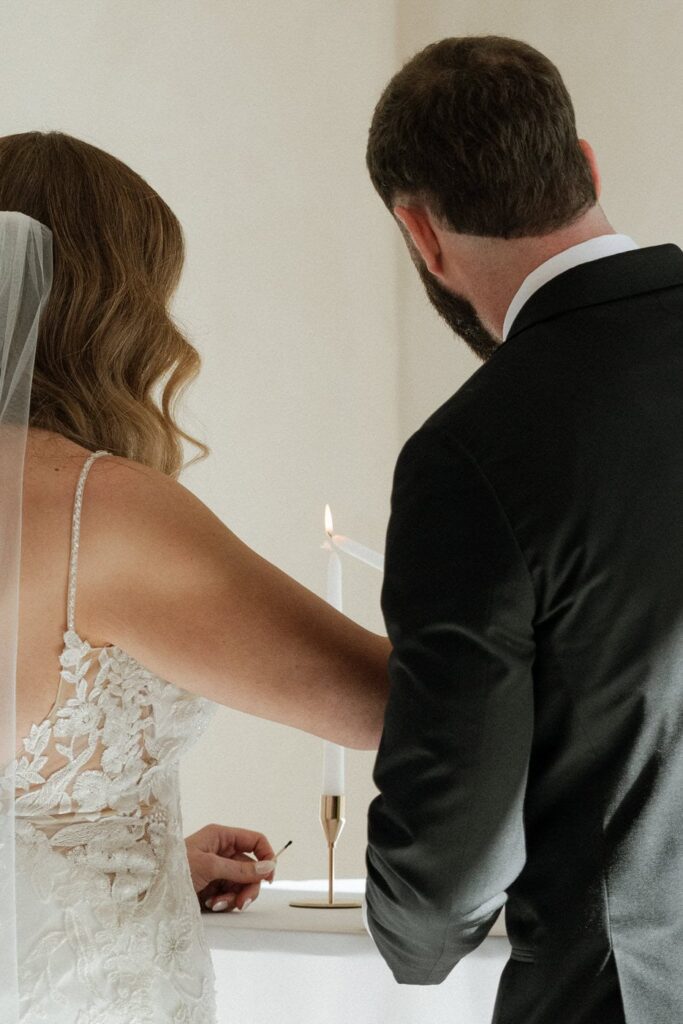 couple lighting candles during ceremony at the monroe on 415th wedding