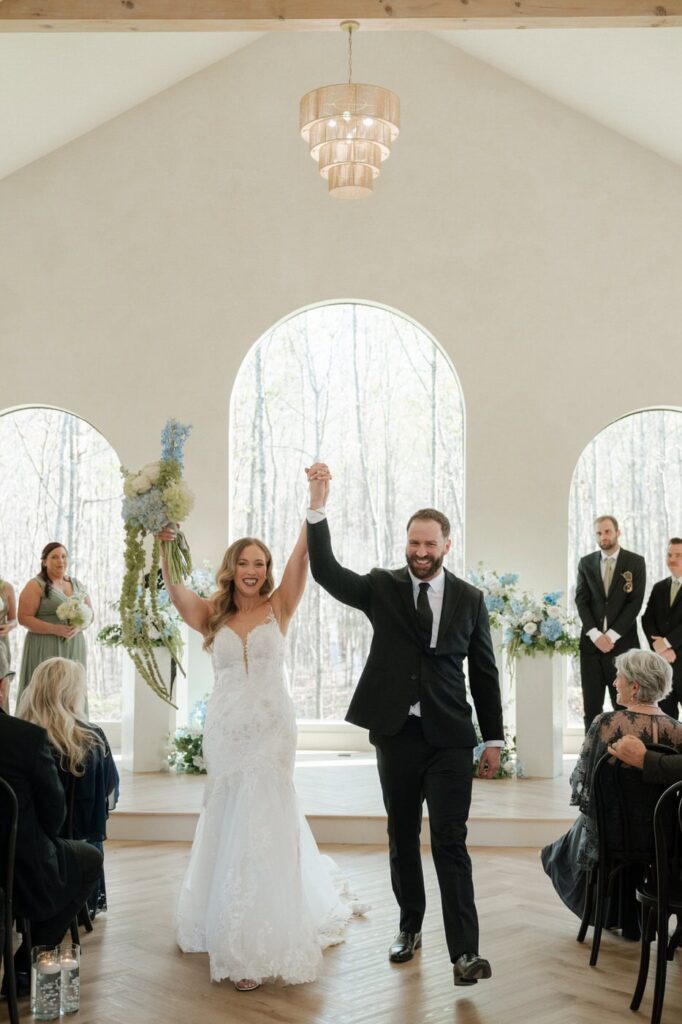 couple holding hands and walking down the aisle after wedding in nashville tennessee