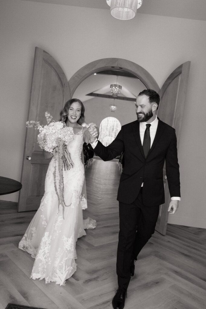 the monroe on 415th wedding couple laughing as they exit their ceremony