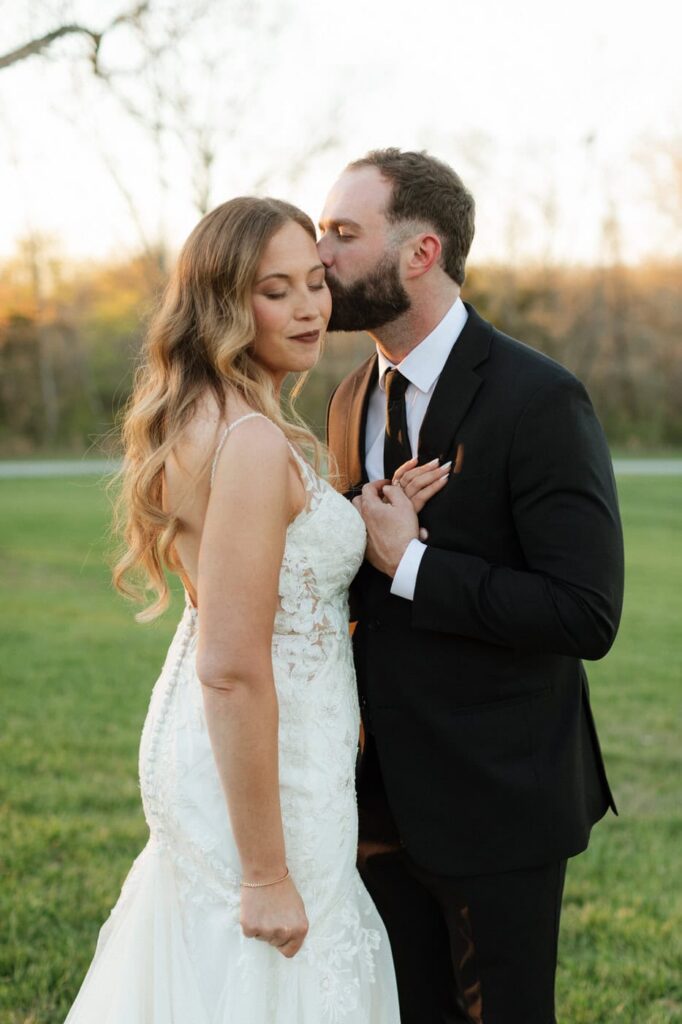 groom kissing the bride's cheek at the monroe on 415th wedding