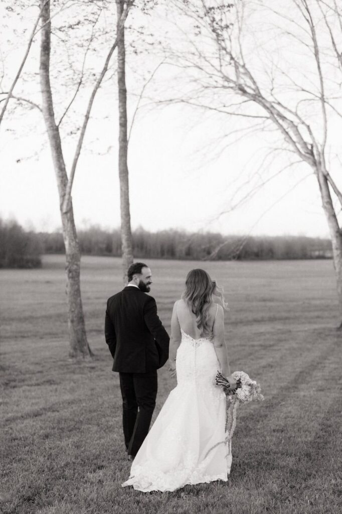 couple holding hands and laughing while walking at nashville spring wedding