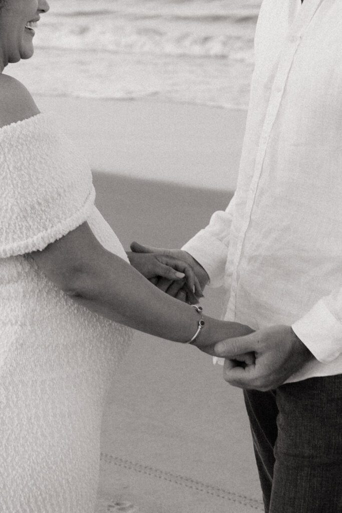 couple holding hands on the beach