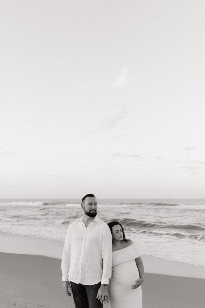 editorial photo of couple looking off into the distance at the beach in virginia beach