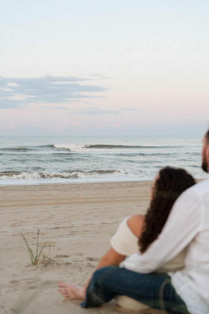 artistic photo of couple looking off at the ocean waves