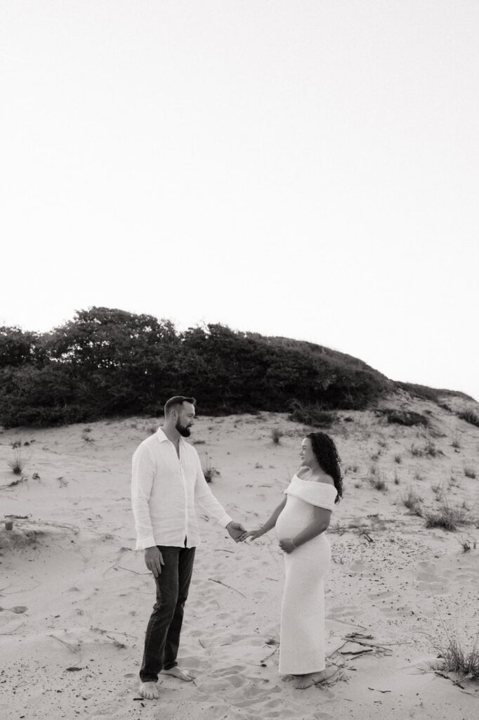 couple holding hands during maternity photos