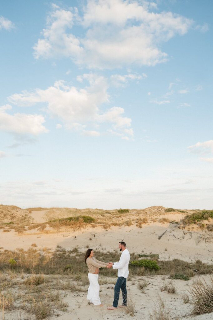couple standing in the dunes at back bay in virginia beach