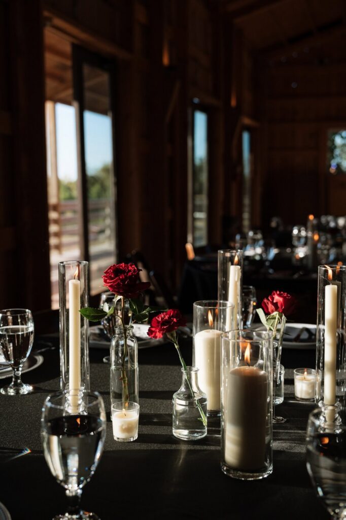 red roses and candlelight reception details at copperline ranch